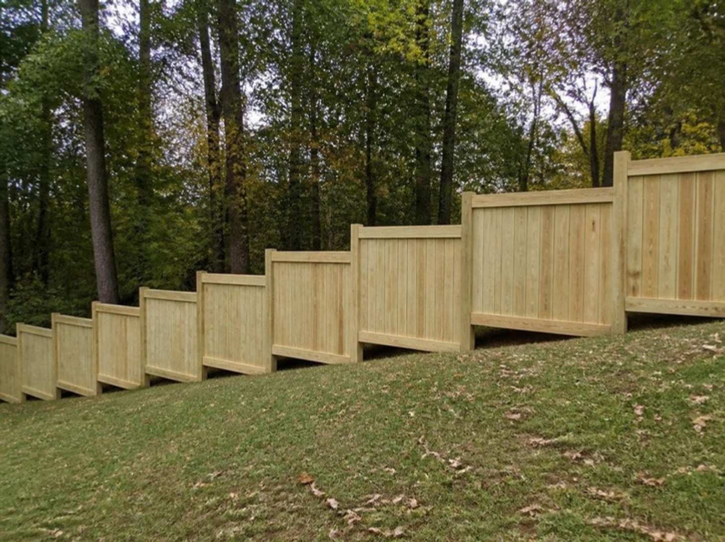 Wood privacy fence built in level stepped sections down a sloped yard